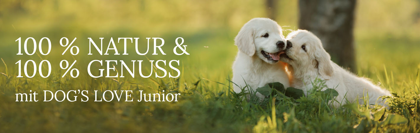 Welpen auf einer Wiese mit Text: 100% Natur & 100% Genuss mit DOG'S LOVE Junior